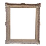 A LARGE 19TH CENTURY ENGLISH CARVED GILTWOOD AND GESSO PICTURE FRAME. (rebate 82cm x 101cm,