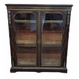 A VICTORIAN EBONISED AND INLAID FLOOR STANDING BOOKCASE Applied with gilt metal mounts, the two