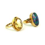 AN EARLY 20TH CENTURY YELLOW METAL AND DOUBLET OPAL RING The oval cut stone in a collet mount,