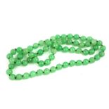 A CHINESE CARVED JADE NECKLACE Having a single strand of spherical beads. (each bead approx diameter