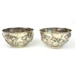 A PAIR OF JAPANESE MEIJI SPHERICAL SILVER BOWLS With embossed high relief organic decoration, marked