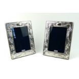 A PAIR OF ART NOUVEAU STYLE HALLMARKED SILVER PHOTOGRAPH FRAMES Embossed with stylized