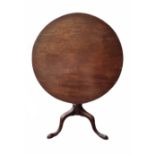 A GEORGIAN MAHOGANY TILT TOP SUPPER TABLE Supported on a turned column raised on three splayed