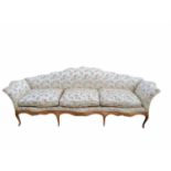 AN 18TH CENTURY ITALIAN WALNUT SETTEE The shaped humped back and scroll ends upholstered in a floral