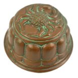 A VICTORIAN TIN AND COPPER JELLY MOULD The base embossed with spider pattern. (top diameter 20.5cm x