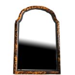 AN EARLY 20TH CENTURY TORTOISE SHELL FRAMED MIRROR with rippled border and domed topped silvered