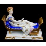 A LATE 19TH/EARLY 20TH CENTURY CONTINENTAL PORCELAIN FIGURE Titled 'Madame Recamier', a reclining