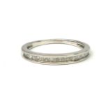 A WHITE METAL AND DIAMOND HALF ETERNITY RING Having a single row of channel set baguette cut