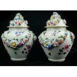 A PAIR OF LATE 19TH/EARLY 20TH CENTURY CONTINENTAL PORCELAIN VASE AND COVERS Having applied floral