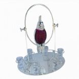A SILVER PLATE AND CRANBERRY GLASS 'PARROT' DECANTER SET A cranberry glass decanter with silver