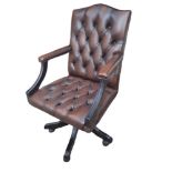 A BUTTON BACK TAN LEATHER LIBRARY DESK CHAIR On a swivel base. (60cm x 67cm x 100cm) Condition: good