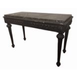 A 19TH CENTURY SIDE TABLE The black marble inset top on a black stand with carved apron, standing on