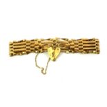 A VINTAGE 9CT GOLD GATE BRACELET Five pierced bars fastened with a heart form clasp. (approx 17cm)