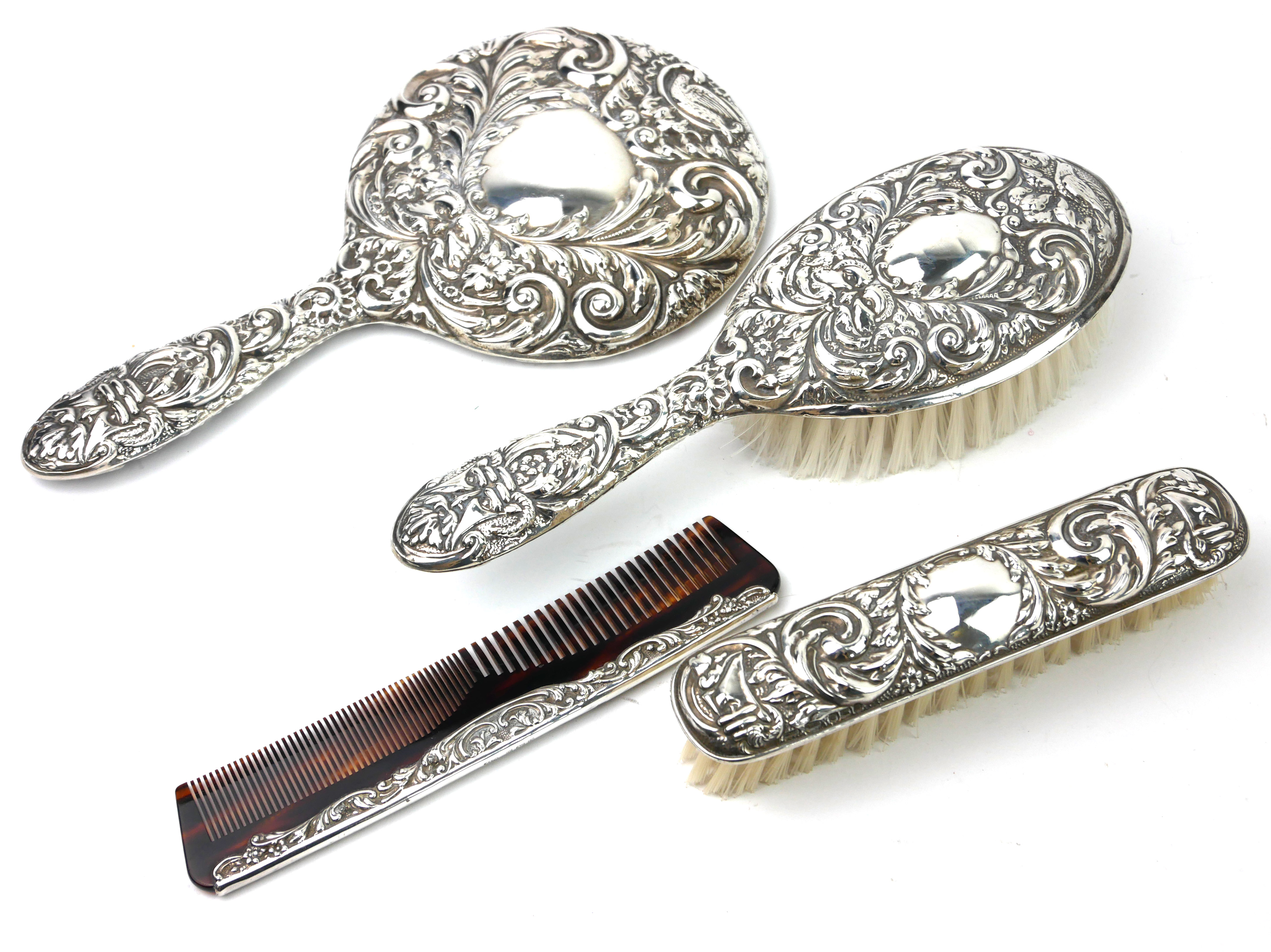 A 20TH CENTURY STERLING SILVER VANITY SET Comprising a hand mirror, hairbrush, tortoiseshell comb