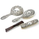 A 20TH CENTURY STERLING SILVER VANITY SET Comprising a hand mirror, hairbrush, tortoiseshell comb