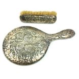 AN EDWARDIAN SILVER HAND MIRROR AND CLOTHES BRUSH Having embossed decoration of winged cherubs,