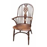 A 19TH CENTURY ASH AND ELM WINDSOR CHAIR Having a pierced splat back, solid saddle seat and