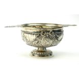 A 19TH CENTURY FRENCH SILVER QUAICH/PORRINGER Having twin handles, the fluted body with embossed