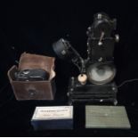 AN EARLY 20TH CENTURY BABY FILM PROJECTOR Black painted metal finish with winding handle, spare