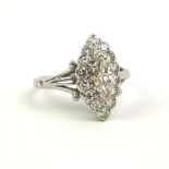 AN EARLY 20TH CENTURY WHITE METAL AND DIAMOND MARQUISE RING The central diamond edged with round cut