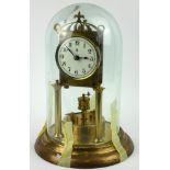 A 20TH CENTURY GILT BRASS ANNIVERSARY CLOCK Having column supports with revolving pendulum and glass