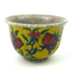 A CHINESE YELLOW GROUND AND CRACKLE GLAZE PORCELAIN TEA BOWL Decorated with strawberries, bearing