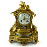 A 19TH CENTURY FRENCH BRONZE ORMOLU AND PORCELAIN MANTLE CLOCK The finial set with a pair of