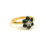 A VINTAGE 18CT GOLD, DIAMOND AND TOURMALINE RING The central diamond edged with green tourmaline