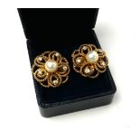 A PAIR OF YELLOW METAL, PEARL AND DIAMOND EARRINGS The central single pearl edged with diamonds in a