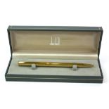 DUNHILL, A VINTAGE GOLD PLATED BALLPOINT PEN Having a pinstripe design, in a fitted Dunhill box. (