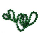 A CHINESE CARVED MALACHITE NECKLACE Having a single strand of spherical beads. (each bead approx