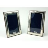 A PAIR OF MODERN LONDON HALLMARKED SILVER PHOTOGRAPH FRAMES With beaded border decoration. (15cm x