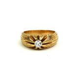 A VINTAGE 14CT GOLD AND DIAMOND GENT'S SIGNET RING The single round cut diamond flanked by texture