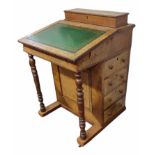 A VICTORIAN WALNUT DAVENPORT DESK The green tooled leather surface above an arrangement of four