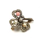 A VICTORIAN YELLOW METAL, DIAMOND AND CORAL 'SHAMROCK' BROOCH Two pearls and a pink coral bead edged