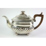 AN EARLY 19TH CENTURY WHITE METAL RECTANGULAR TEAPOT With floral finial, carved wooden handle and