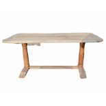 A RUSTIC STRIPED MAHOGANY DINING TABLE Raised on turned columns supported on a platform base. (w