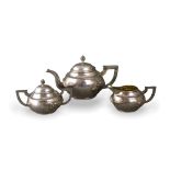 A Chinese export silver teaset ,marked Tuckchong, decorated with dragons, comprising teapot and