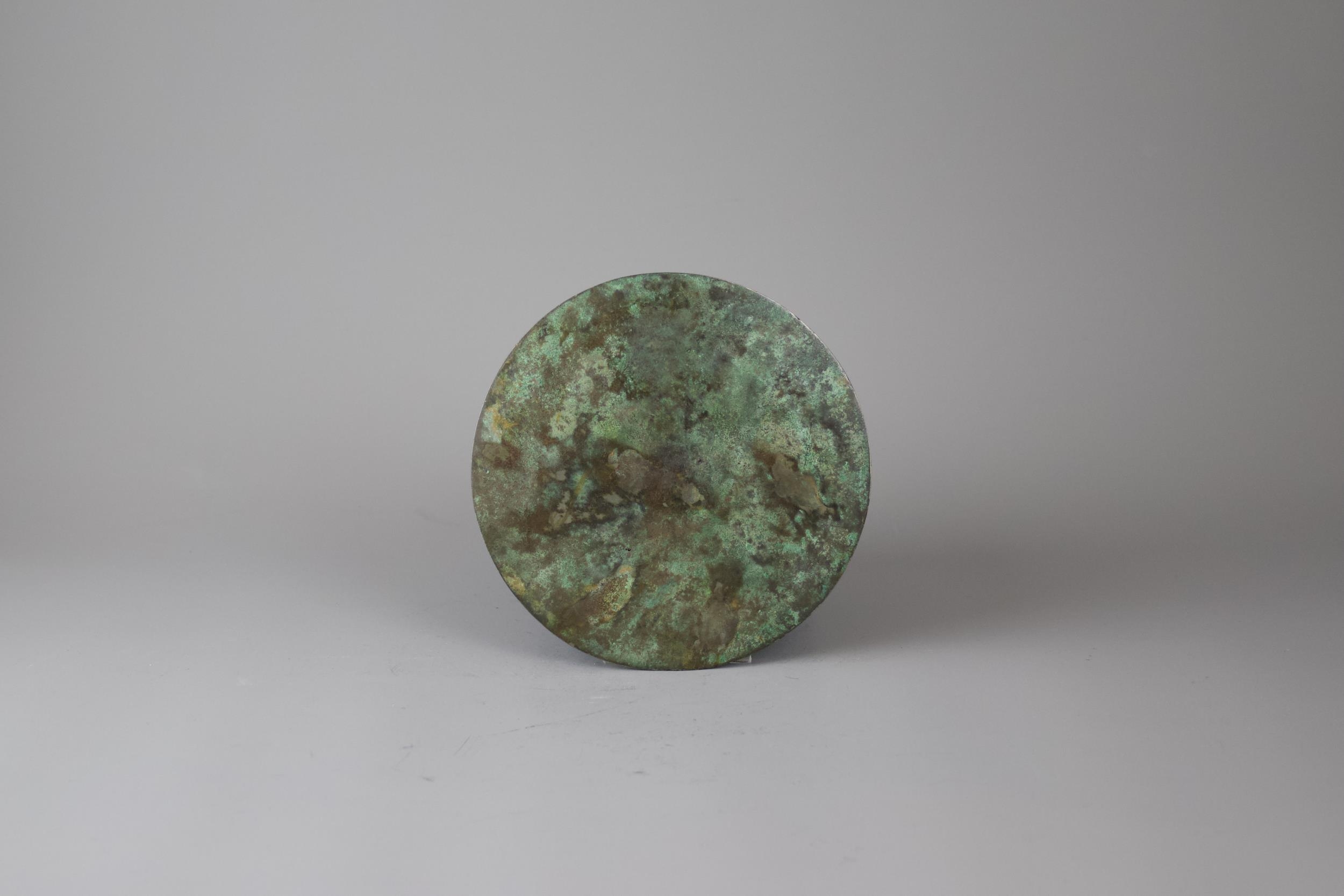 An Archaic Bronze 'TLV' Mirror, Han Dynasty - - H1cm W13.5cm - - the raised central knob enclosed - Image 2 of 3