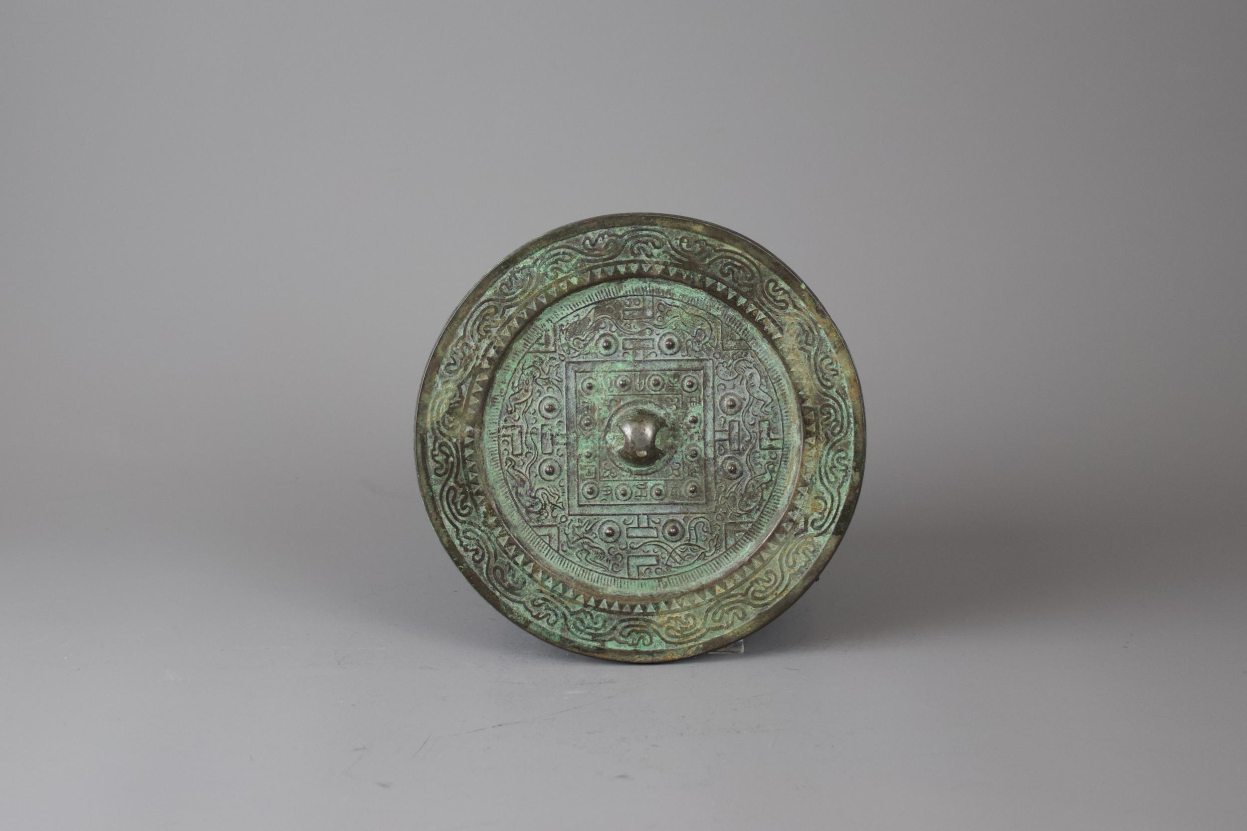 An Archaic Bronze 'TLV' Mirror, Han Dynasty - - H1cm W13.5cm - - the raised central knob enclosed - Image 3 of 3