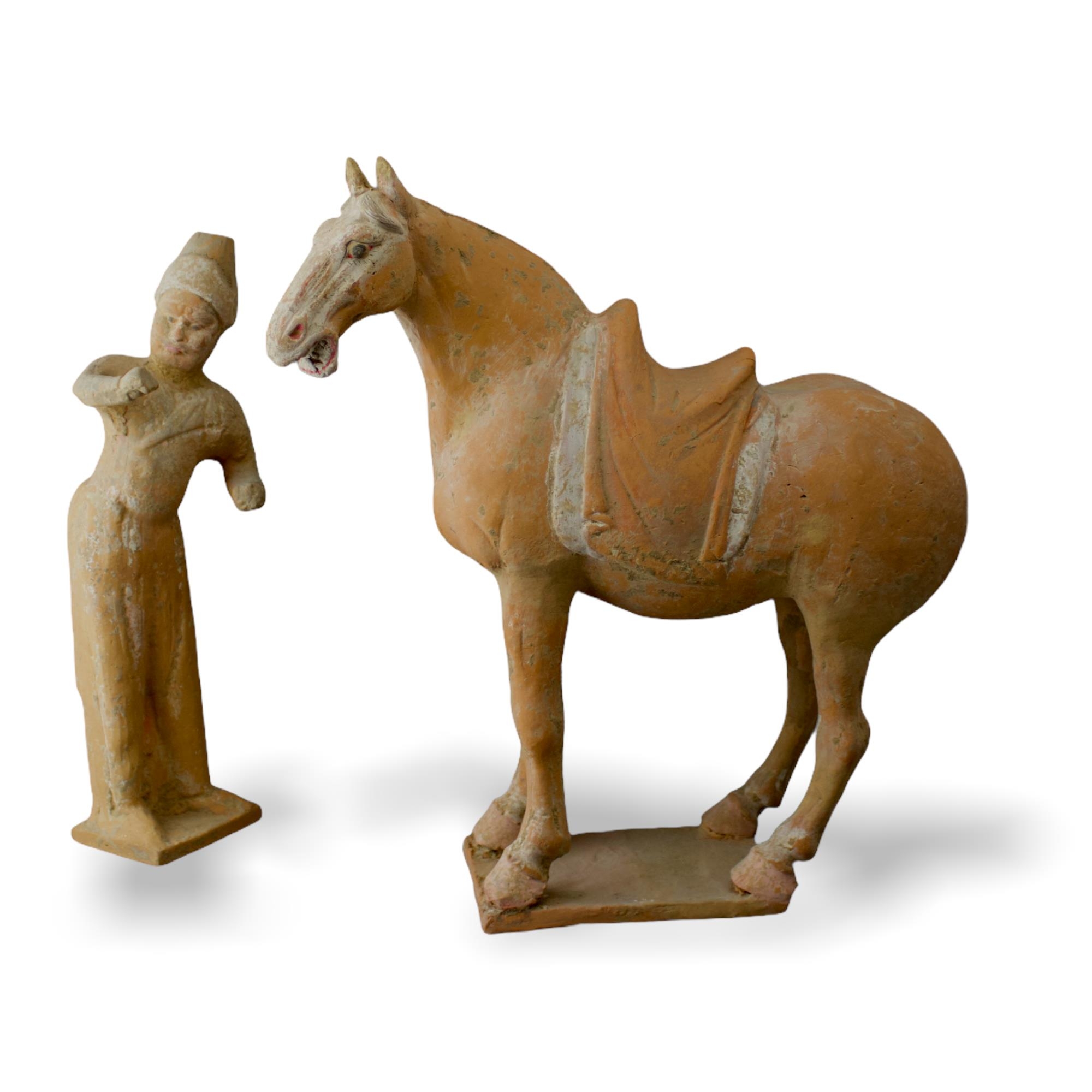 A Painted Pottery Model of a Horse and Foreign Groom, Tang Dynasty - - Horse H 36.5cm - - The