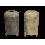 A pair of grey pottery beehive granaries, Han dynasty, standing on tripod feet moulded as bears H