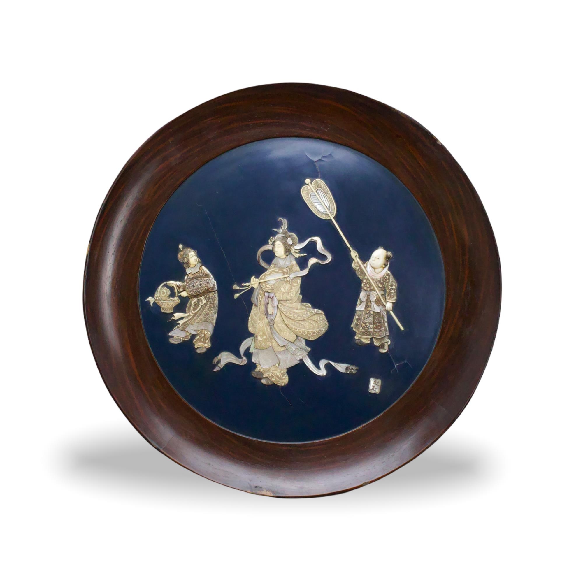 A large Japanese round plaque in lacquer inlaid with mother of pearl and ivory, Meiji period W54.5cm