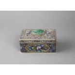 An enamelled rectangular silver filigree box with hinged cover, the lid with raised blooms
