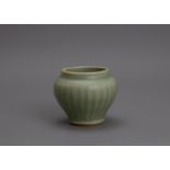 A ribbed Longquan celadon miniature jar and cover, Yuan Dynasty, the glaze of good sea green