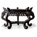 A pierced hardwood stand, Qing Dynasty L14cm D23.5cm with openwork scrollwork apron and five feet.