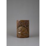 A finely carved and pierced Bamboo Brushpot depicting two scholars seated beneath a pine by a