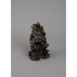 A well cast and amusing bronze figure of Liuhai on his Toad, with a wood stand, c 1700 - - H9cm L5.