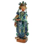 WITHDRAWN A CHINESE GLAZED TERRACOTTA FIGURE OF A FEMALE DEITY, wearing elaborate robes and carrying