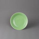 A monochrome dish, Qianlong Mark and of the Period, Later Glazed in Green - - D16.5 cm H3.2 cm - -